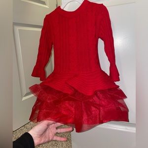 Precious red sweater dress with the cutest flair ruffle.